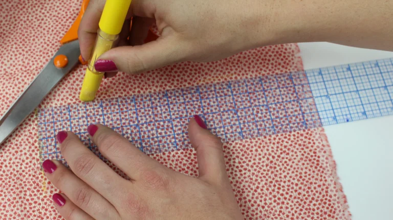 Marking fabric measurements for a quilted wash bag pattern.