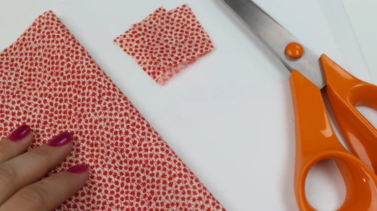 Prepared fabric pieces for zip tabs used in a quilted wash bag.