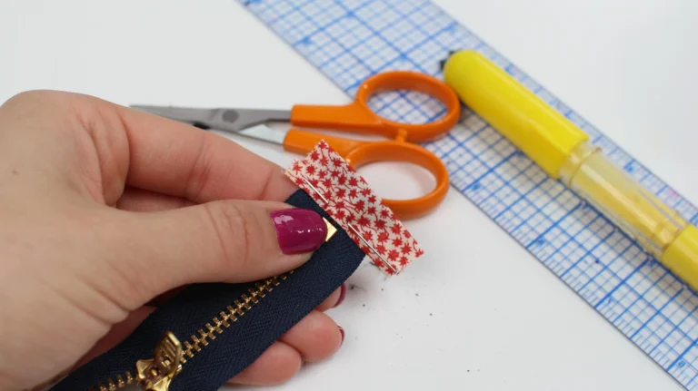 Pinning fabric zip tabs securely to the end of a zip