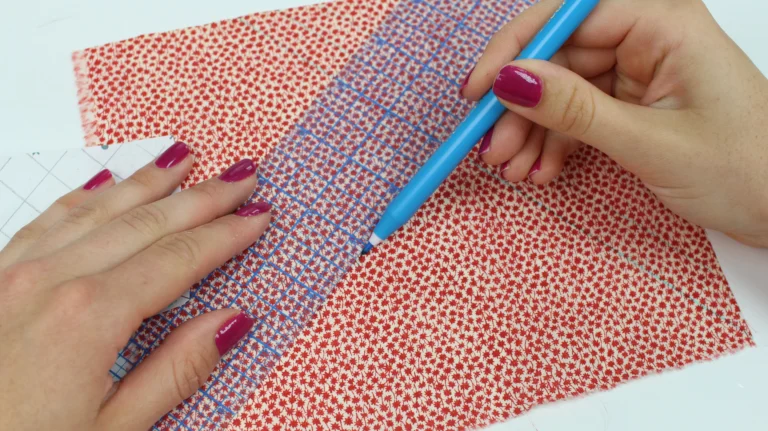 Marking quilting lines onto fabric using a ruler and removable pen