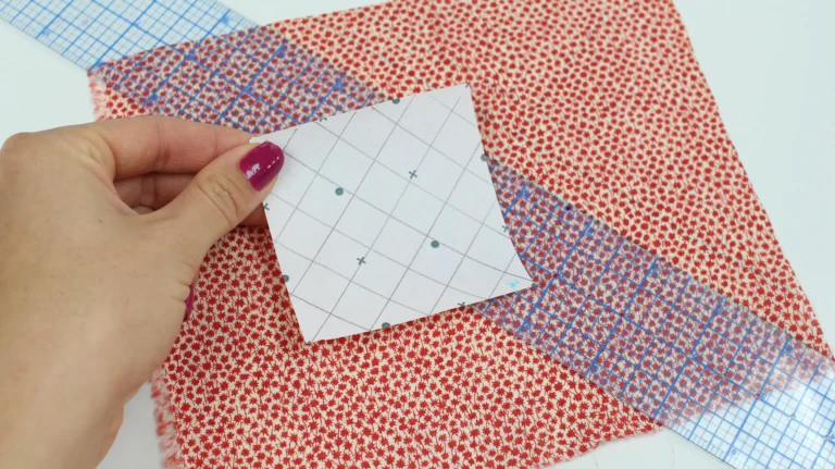 Using a paper template to plan quilting placement on fabric