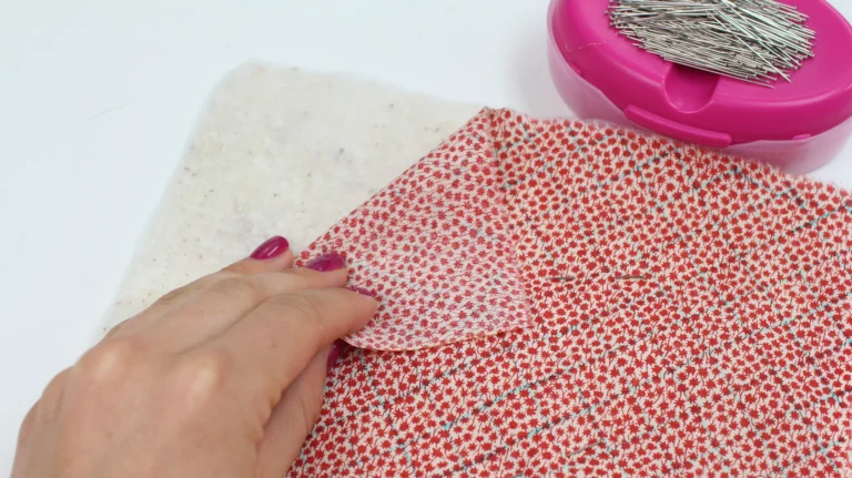 Layering cotton wadding behind fabric before quilting