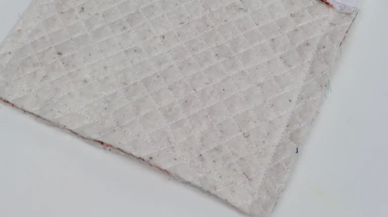 Close-up of quilted wadding attached to a wash bag exterior panel.