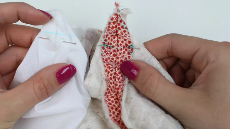 Pinning a boxed corner on a quilted wash bag.