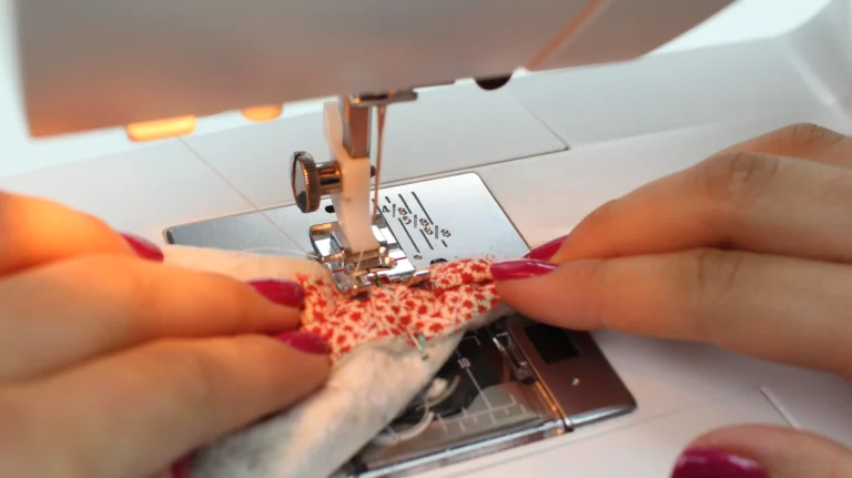 Sewing a boxed corner on a quilted wash bag at the sewing machine.