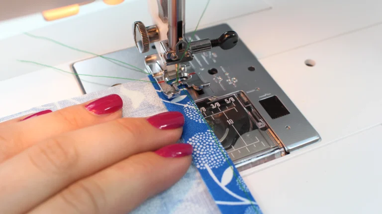 Sewing the second stitch in a rolled hem, folding the fabric towards the wrong side