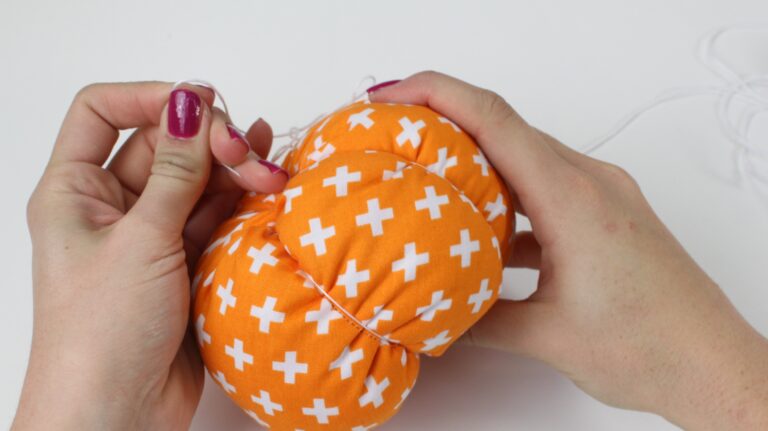 Pull threads through the pumpkin to create sections