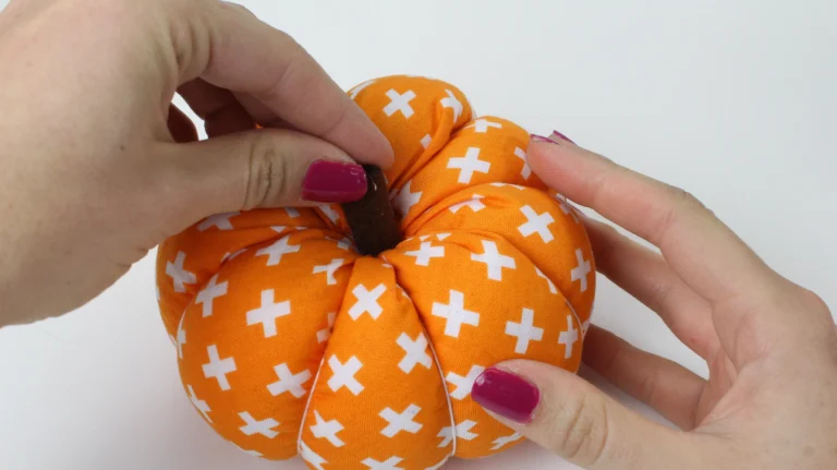 Stick the felt stem onto the top of the fabric pumpkin