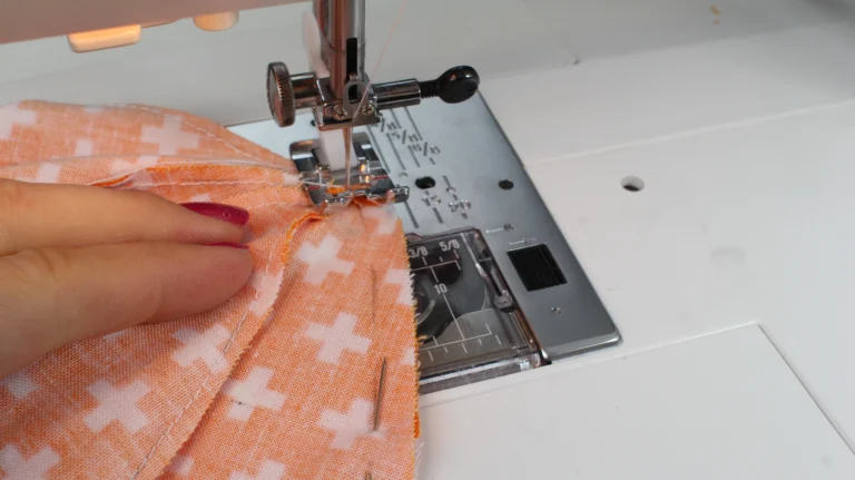 Sewing the four segments of the pumpkin together at the sewing machine