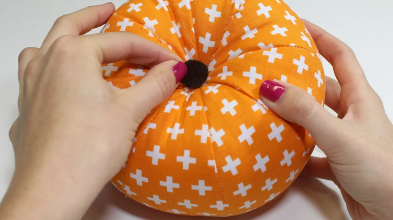 Finish the bottom centre of the pumpkin with a circle cut from felt