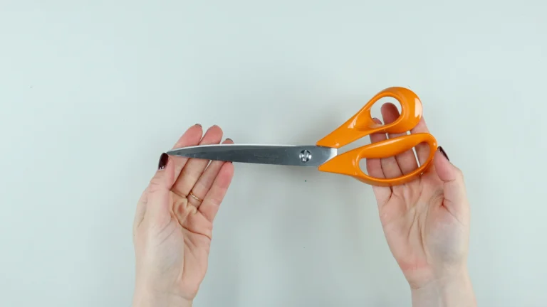 Fiskars 25cm dressmaking scissors held in hands - my most used sewing tool