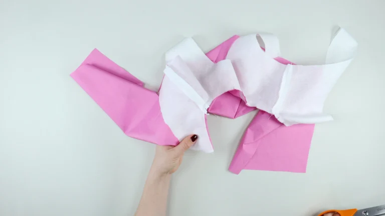 Trimmed and graded seam allowance at the neckline between the bodice and all-in-one facing