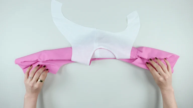 Allow the facing for the side of the armhole that will be sewn to sit right side facing up, all-in-one facing with centre back on fold
