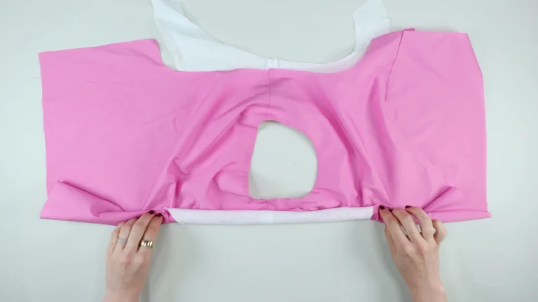 Complete the second side. Roll the garment from one side seam towards the opposite shoulder, for all-in-one facing without centre back seam