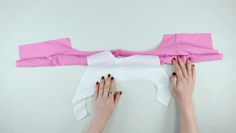 Allow the facing for the second side of the armhole that will be sewn to sit right side facing up, all-in-one facing with centre back on fold