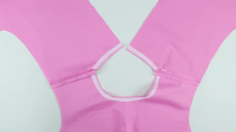 Inside of the garment showing the bodice shoulder seams sewn together and pressed open, ready for the all-in-one facing