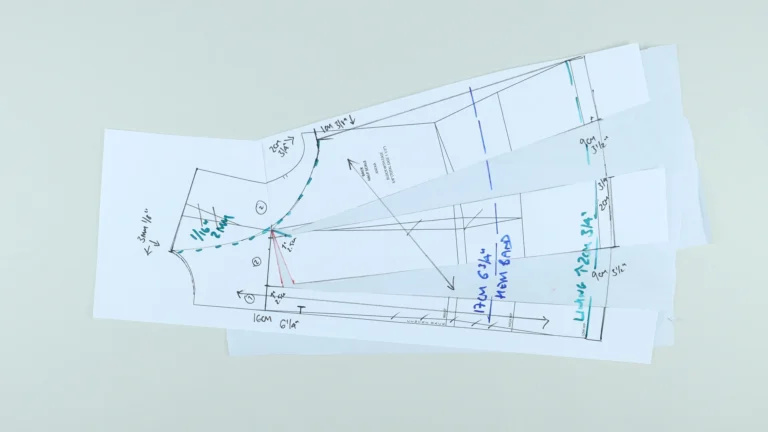 Annotated master pattern for the back of a tie neck halterneck top showing hem band and lining