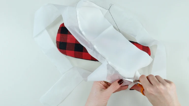 Trimming the excess fabric close to the stitching line when sewing a baby hem on silk charmeuse