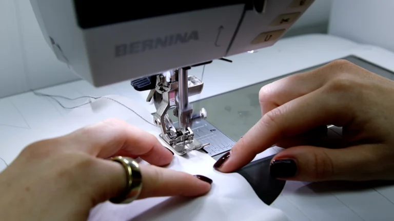 Sewing the first guide stitch for a baby hem on silk charmeuse using a Bernina sewing machine