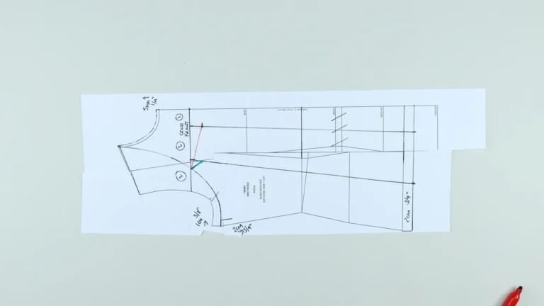 Slash and spread lines marked in red and green on a halterneck top pattern for adding trapeze hem volume