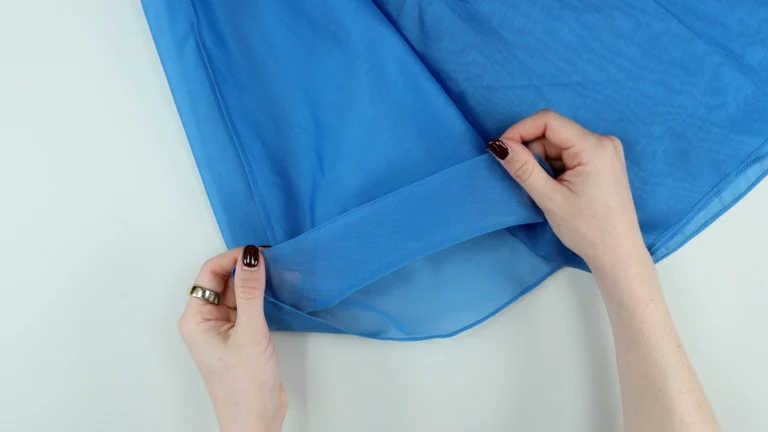 Sewn baby hem on the lining of the tie neck halter neck top