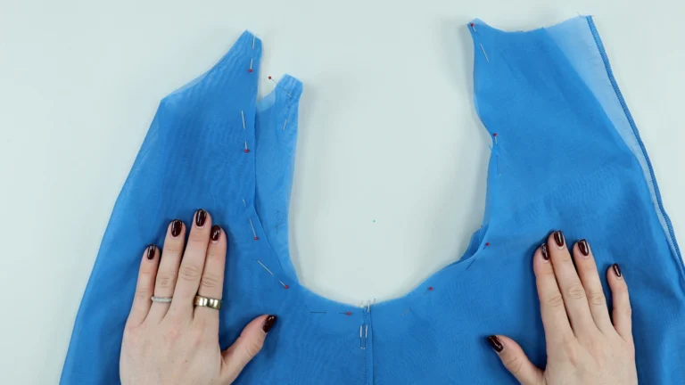 Pinned lining and exterior at the armhole of the tie neck halterneck top