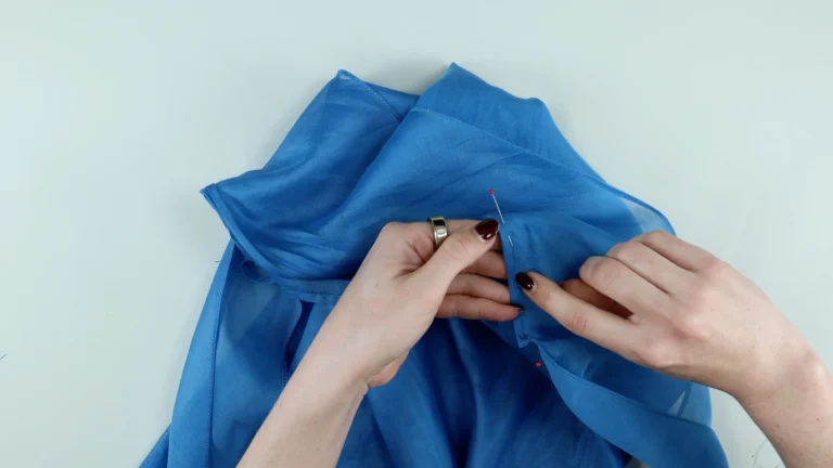Wrap the bias binding around the neck seam allowances and baste for the tie neck halterneck top