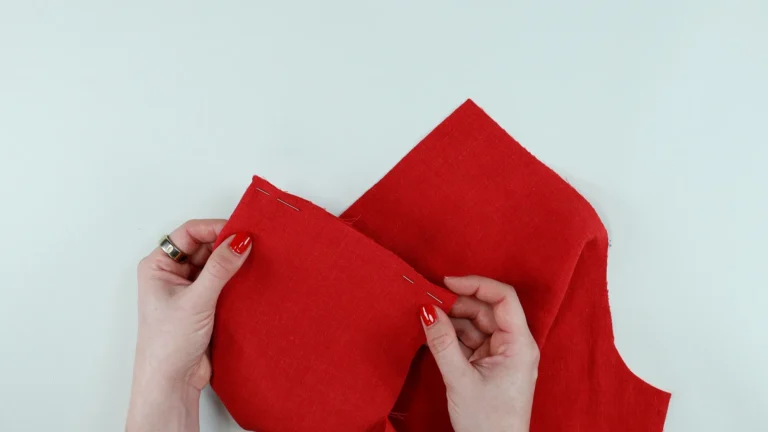Position the bottom edge of the pocket with the fabric wrong sides together to sew a French seam