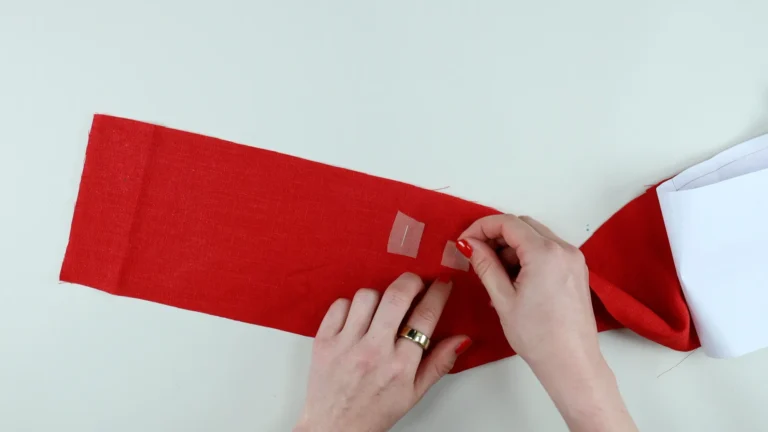 Fuse fusible interfacing onto the wrong side of the buttonholes at the waistband