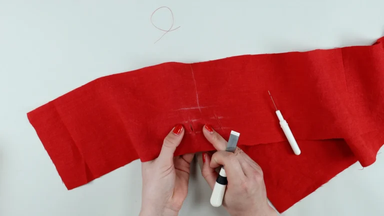 Opened buttonholes with buttonhole cutter on the waistband