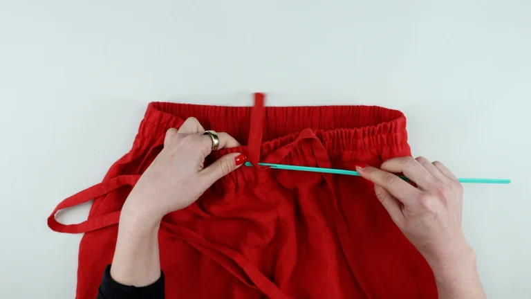 Thread the tie cord through the buttonhole using a bodkin